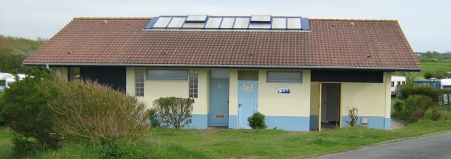 a long low building that is the shower block at the campsite in wimeraux, france